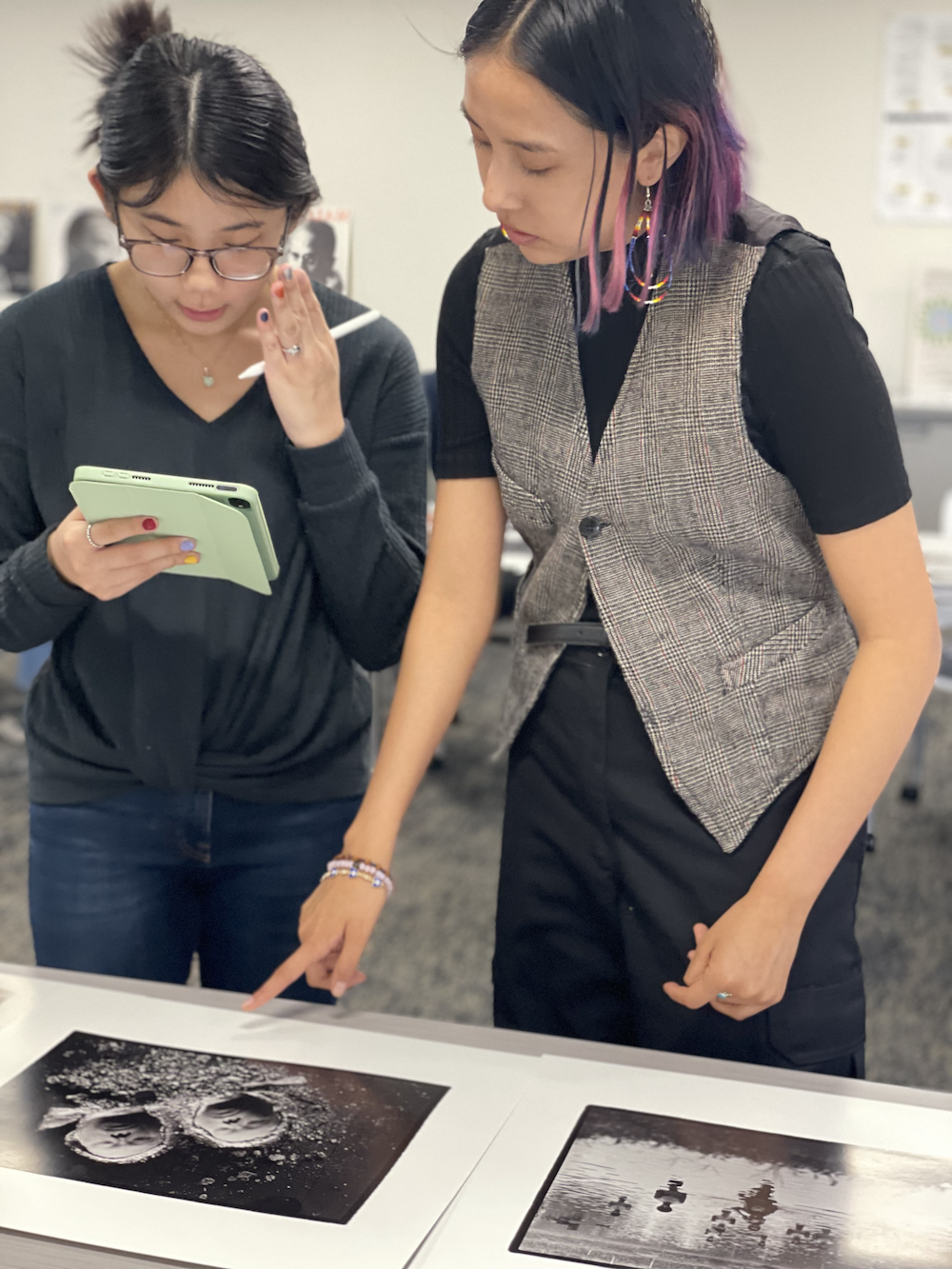 Two students looking at photo